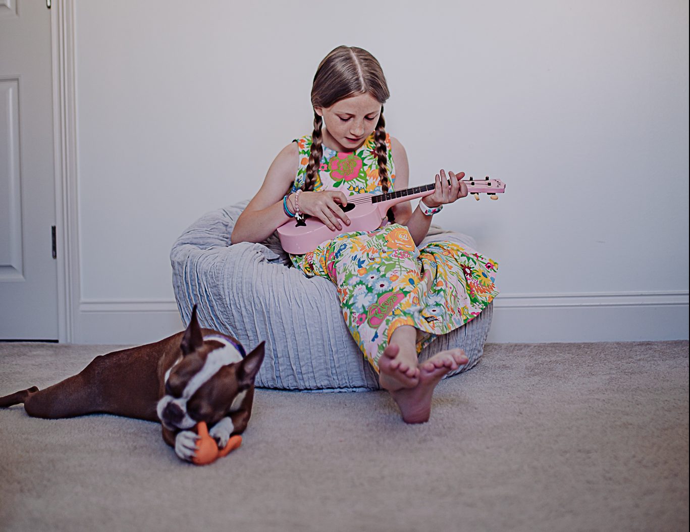 Child and dog playing on carpet
